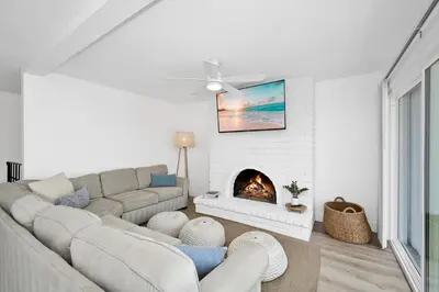 a living room with a couch and a fireplace at 6 Bedroom Duplex near the Balboa Pier and Fun Zone with AC in Newport Beach