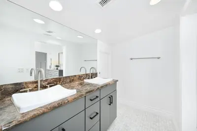 a bathroom with two sinks and a large mirror at Luxury 3 Bedroom walk to Beach & Pier in Newport Beach