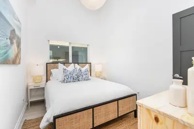 a bedroom with a bed and a window at Luxury 3 Bedroom walk to Beach & Pier in Newport Beach