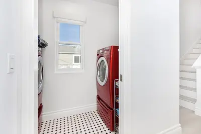 a red washing machine in a laundry room with a window at Luxury 3 Bedroom walk to Beach & Pier in Newport Beach