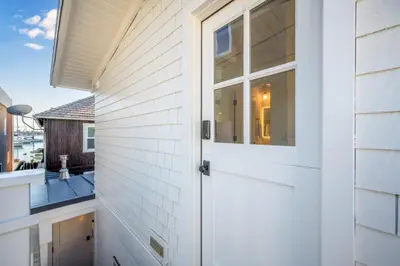 a white door on a house with a balcony at Balboa Island Luxury Penthouse Suite With Bay Views in Newport Beach