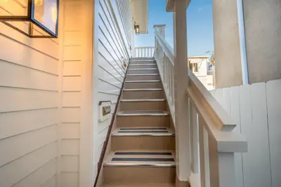 a stairway in a home with a white wall at Balboa Island Luxury Penthouse Suite With Bay Views in Newport Beach
