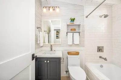 a bathroom with a sink and a toilet and a tub at Balboa Island Luxury Penthouse Suite With Bay Views in Newport Beach