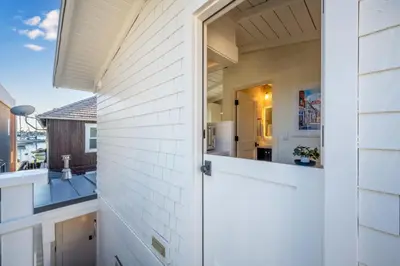 a door to a house with a view of a kitchen at Balboa Island Luxury Penthouse Suite With Bay Views in Newport Beach