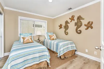 a bedroom with two beds and a window at 1 House from the Sand with Rooftop Deck on 28th Street in Newport Beach