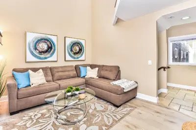 a living room with a couch and a table at 1 House from the Sand with Rooftop Deck on 28th Street in Newport Beach