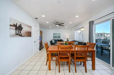 a dining room and living room with a table and chairs at 6 Bedroom home located 2 houses in from the Beach in Newport Beach