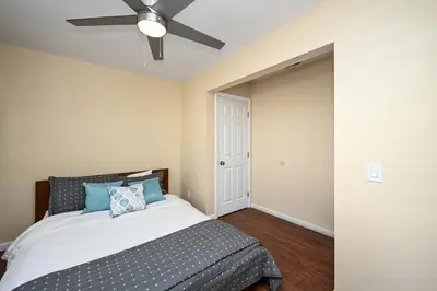 a bedroom with a bed and a ceiling fan at Giant Home Sleep 20, Perfect for Multi Family Vacation steps from the Sand in Newport Beach