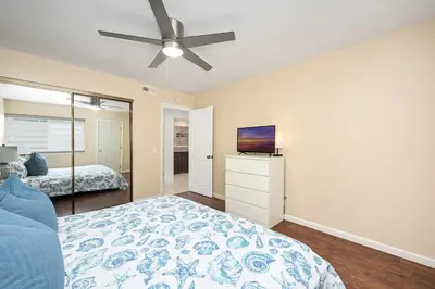 a bedroom with a bed and a ceiling fan at Giant Home Sleep 20, Perfect for Multi Family Vacation steps from the Sand in Newport Beach