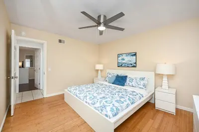 a bedroom with a bed and a ceiling fan at Giant Home Sleep 20, Perfect for Multi Family Vacation steps from the Sand in Newport Beach