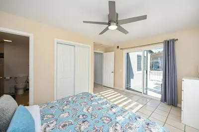 a bedroom with a bed and a ceiling fan at Giant Home Sleep 20, Perfect for Multi Family Vacation steps from the Sand in Newport Beach