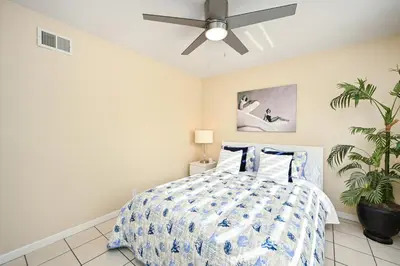 a bedroom with a bed with a ceiling fan at Giant Home Sleep 20, Perfect for Multi Family Vacation steps from the Sand in Newport Beach