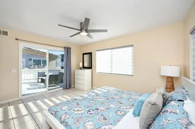 a bedroom with a bed and a ceiling fan at Giant Home Sleep 20, Perfect for Multi Family Vacation steps from the Sand in Newport Beach