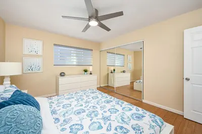 a bedroom with a bed and a ceiling fan at Giant Home Sleep 20, Perfect for Multi Family Vacation steps from the Sand in Newport Beach