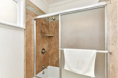a shower with a glass door in a bathroom at 7 Bedroom Duplex Home with Rooftop & Peek-A-Boo Ocean View in Newport Beach