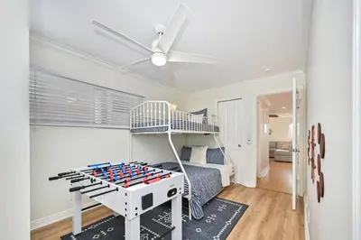 a bedroom with a bunk bed and a play table at 7 Bedroom Duplex Home with Rooftop & Peek-A-Boo Ocean View in Newport Beach