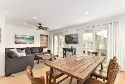 a living room with a table and a couch at 4 Bedroom Home with Rooftop & Peek-A-Boo Ocean View in Newport Beach