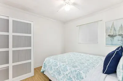 a bedroom with a bed and a ceiling fan at 4 Bedroom Home with Rooftop & Peek-A-Boo Ocean View in Newport Beach