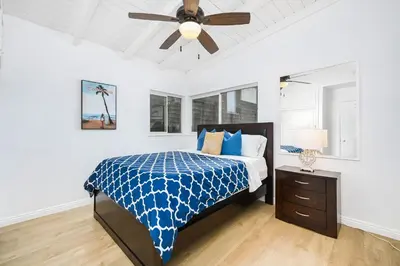 a bedroom with a bed and a ceiling fan at 2 Bedroom Upstairs with Balcony Steps from the Sand in Newport Beach