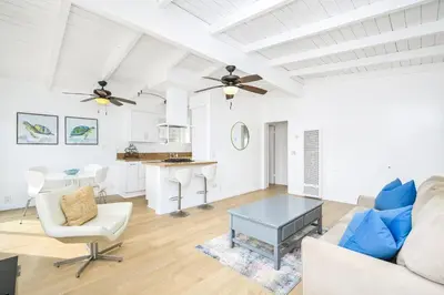 a living room with a couch and a table at 5 Bedroom Duplex 1 minute Walk to the Ocean in Newport Beach