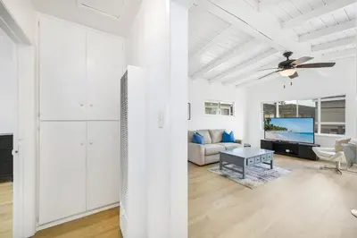 a living room with a ceiling fan and a couch at 5 Bedroom Duplex 1 minute Walk to the Ocean in Newport Beach