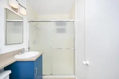 a bathroom with a shower and a sink at 5 Bedroom Duplex 1 minute Walk to the Ocean in Newport Beach