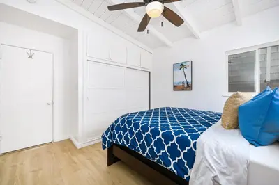 a bedroom with a bed and a ceiling fan at 5 Bedroom Duplex 1 minute Walk to the Ocean in Newport Beach