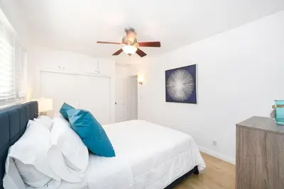 a bedroom with a bed and a ceiling fan at Renovated 3 Bedroom Home on 41st-1 min walk to Beach in Newport Beach