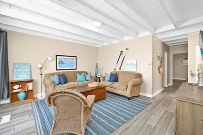 a living room with two couches and a table at 5 Bedroom 4 Bath Duplex with Parking on 46th St! in Newport Beach