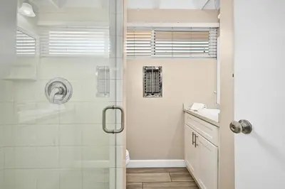 a bathroom with a shower and a sink at 2 Bedroom Upstairs Apt 1 block from the beach! in Newport Beach