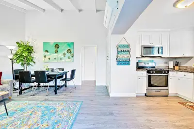 a kitchen and dining room with a table and chairs at 4 Bedroom Across from the Beach and Boardwalk in Newport Beach