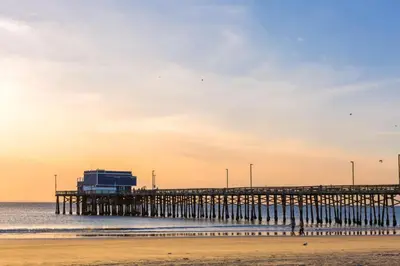 a pier in the ocean with a beach at 4 Bedroom Across from the Beach and Boardwalk in Newport Beach