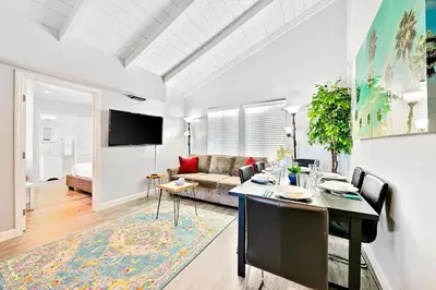 a living room with a table and a couch at Duplex Across the Street from Beach & Boardwalk in Newport Beach
