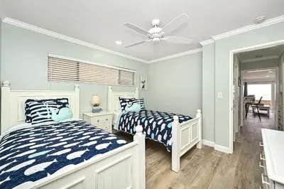 a bedroom with two beds and a ceiling fan at Multi Level Oceanfront Home With Oceanviews and Private Patio on the Boardwalk in Newport Beach