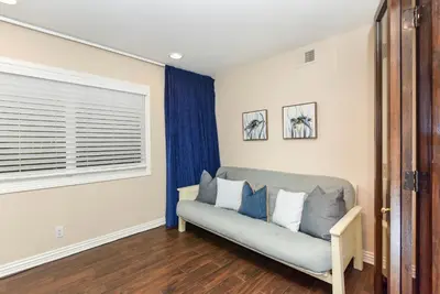 a living room with a couch and a window at Multi Level Oceanfront Home With Oceanviews and Private Patio on the Sand in Newport Beach