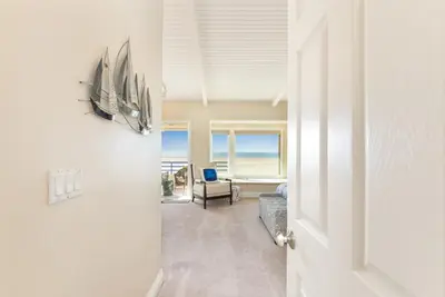 an open door to a room with a view of the ocean at Multi Level Oceanfront Home With Oceanviews and Private Patio on the Sand in Newport Beach