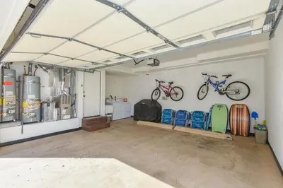 a garage with two bikes hanging on the wall at Multi Level Oceanfront Home With Oceanviews and Private Patio on the Sand in Newport Beach