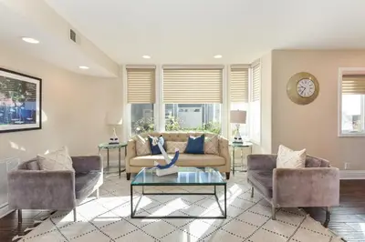 a living room with a couch and two chairs and a table at 7 Bedroom Oceanfront Home & Back House in Newport Beach