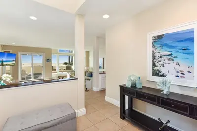 a living room with a large painting on the wall at 7 Bedroom Oceanfront Home & Back House in Newport Beach