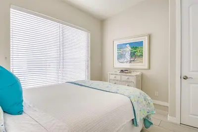 a white bedroom with a bed and a window at New Renovated Beach Home with Ocean Views in Newport Beach