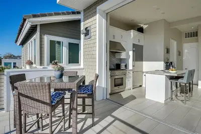 a kitchen and dining room with a table and chairs at New Renovated Beach Home with Ocean Views in Newport Beach