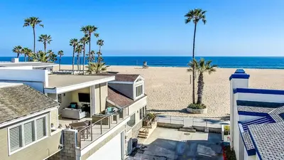 a view of the beach from the balcony of a house at New Renovated Beach Home with Ocean Views in Newport Beach