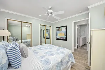 a bedroom with a bed and a ceiling fan at Updated Home with Patio on the Boardwalk near 15th St in Newport Beach