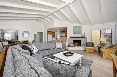 a living room with a couch and a table at Oceanfront Triplex on Boardwalk with Ocean Views and Patio in Newport Beach