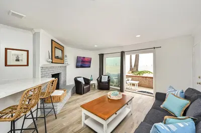 a living room with a couch and a table at Oceanfront Triplex on Boardwalk with Ocean Views and Patio in Newport Beach