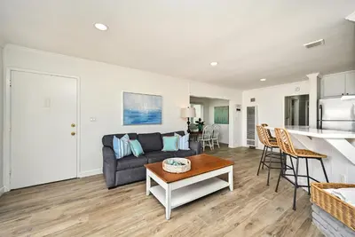 a living room with a couch and a table at Oceanfront Triplex on Boardwalk with Ocean Views and Patio in Newport Beach