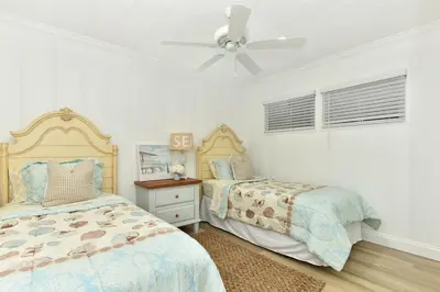 a bedroom with two beds and a ceiling fan at Updated Home on the Boardwalk with Private Rear Unit in Newport Beach