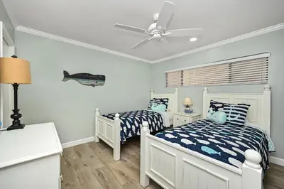 a bedroom with two beds and a ceiling fan at Updated Home on the Boardwalk with Private Rear Unit in Newport Beach