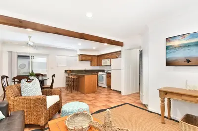 a living room with a couch and a table at 2 Bedroom BACK Apt at OCEANFRONT HOME on 15th St in Newport Beach