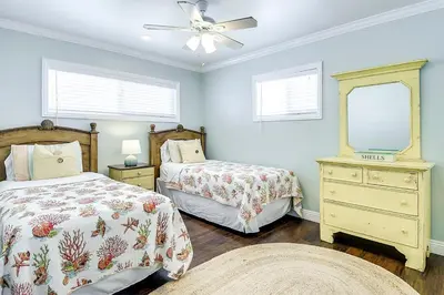 a bedroom with two beds and a ceiling fan at TWO BEACHFRONT BUNGALOWS ON THE SAND IN Newport Beach in Newport Beach